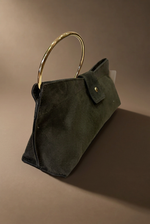 Cargue la imagen en el visor de la galería,Clutch verde em vista lateral com aro dourado, fundo castanho quente
