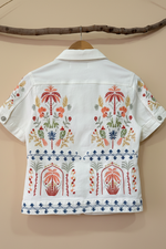 Carica l'immagine nel visualizzatore della galleria,Embroidered white denim jacket back view studio background
