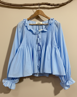 Chargez l'image dans la visionneuse de la galerie,Light blue pleated blouse front view - dramatic studio background
